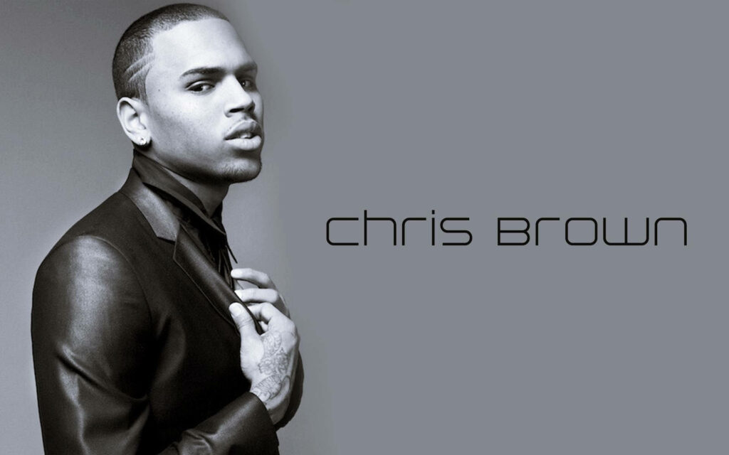 Chris Brown grayscale wallpaper in sleek suit confident pose minimalist background design