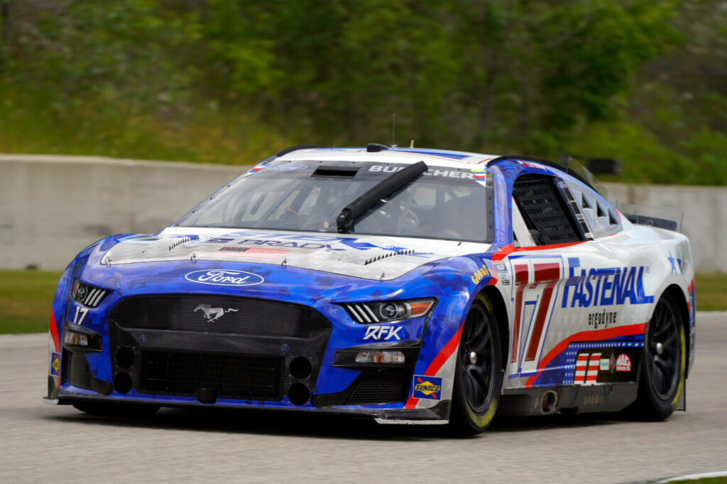 Chris Buescher No 17 Ford Mustang fastenal race car speeding on track with vibrant graphics Wallpaper