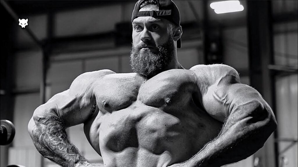 Chris Bumstead front lat spread grayscale wallpaper showing muscle definition gym background