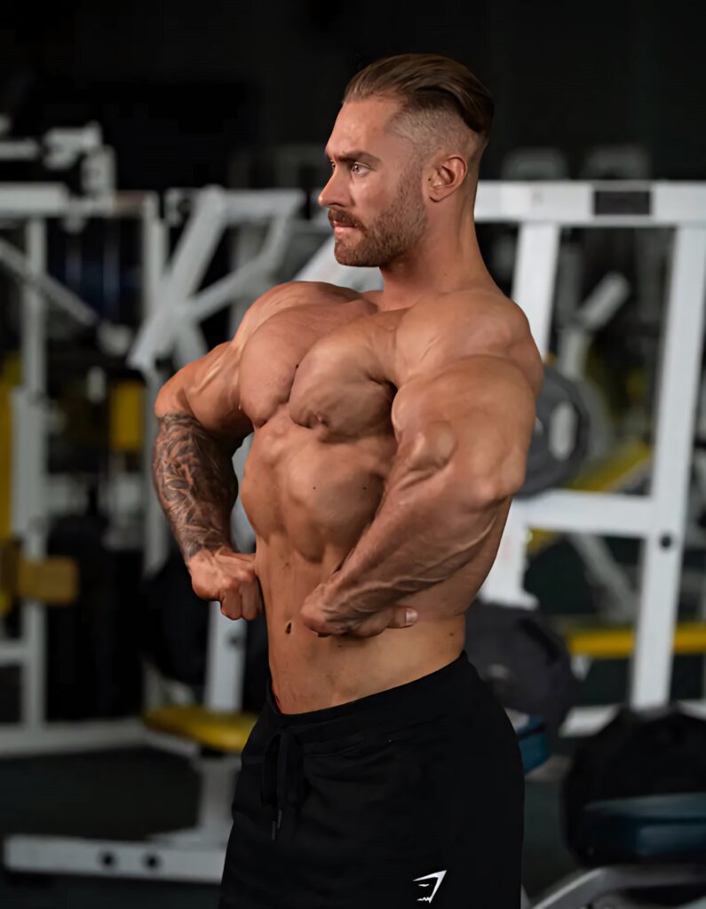 Chris Bumstead side profile lat spread showing muscular definition vascularity classic physique Wallpaper