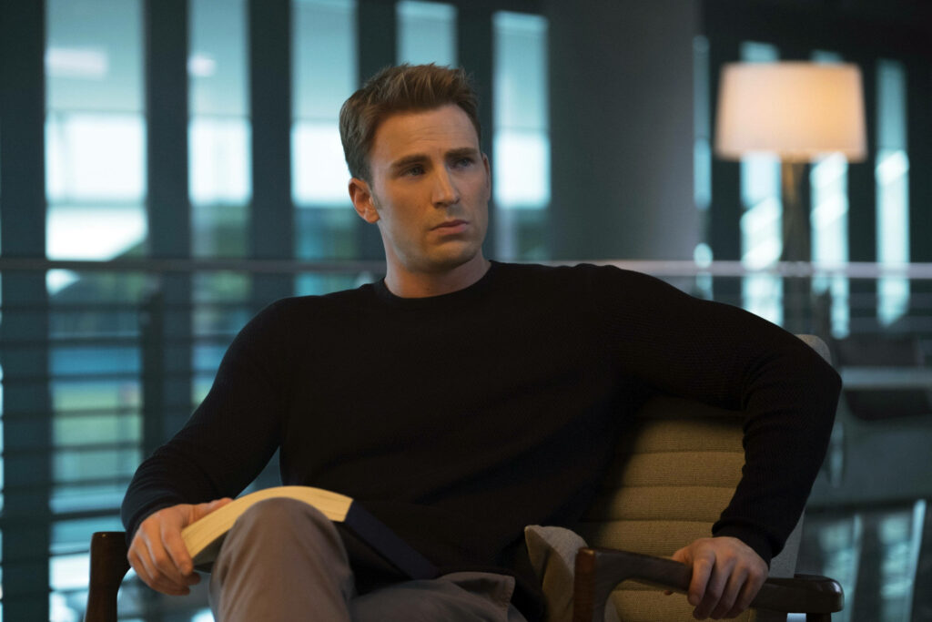 Chris Evans contemplative portrait with soft indoor lighting and blurred neutral modern background wallpaper