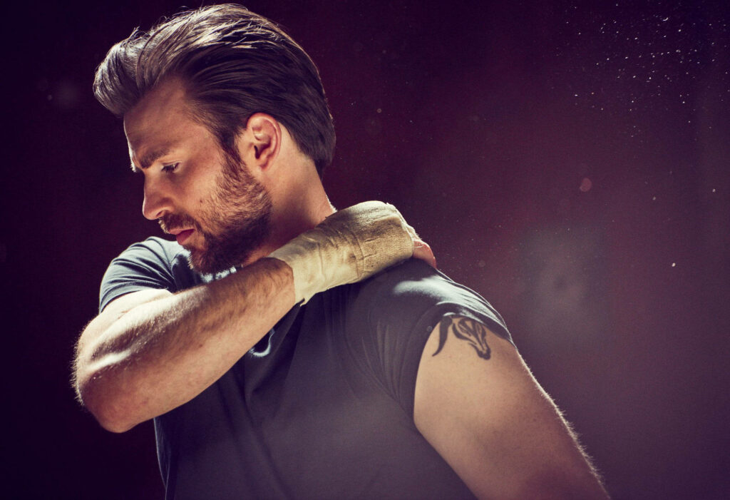 Chris Evans muscular pose tattoo warm tones cinematic wallpaper background strength intensity