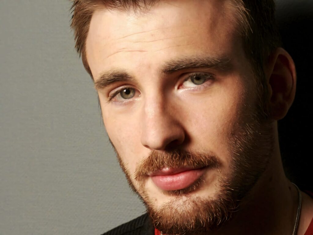 Chris Evans close-up portrait with expressive eyes and groomed beard on gray background wallpaper