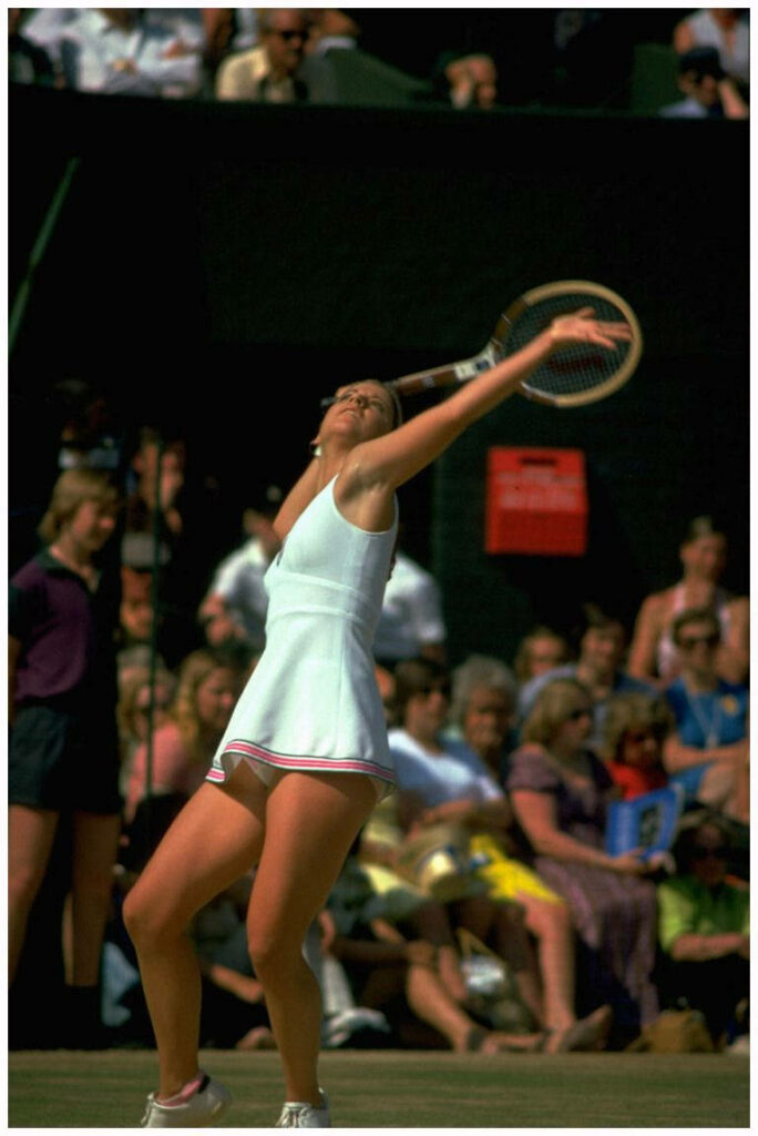 Chris Evert mid serve tennis match white outfit intense focused crowd wallpaper background