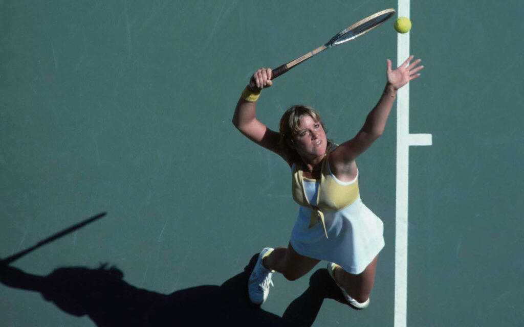 Chris Evert tennis serve action focused athlete dynamic movement green court wallpaper background