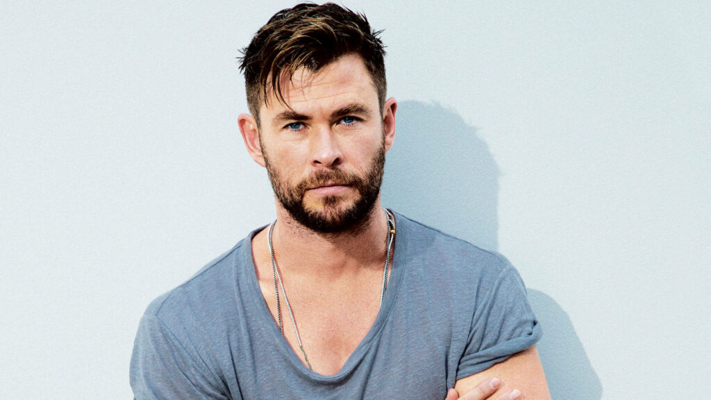Chris Hemsworth casual style wallpaper relaxed pose light background confident expression