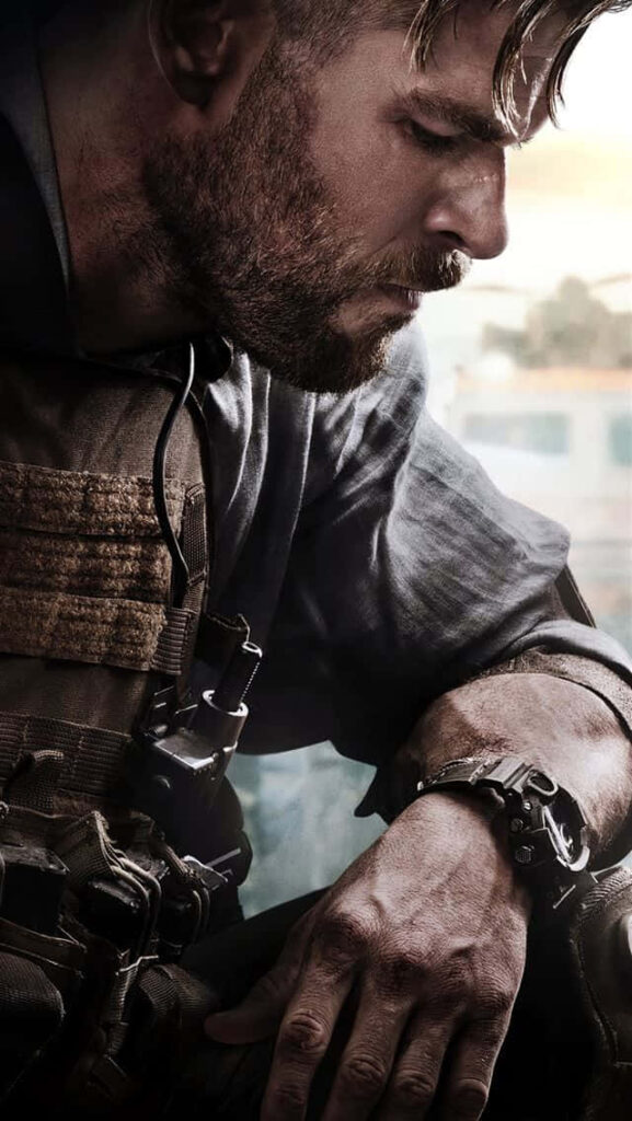 Chris Hemsworth in Extraction tactical gear intense action scene determined expression wallpaper