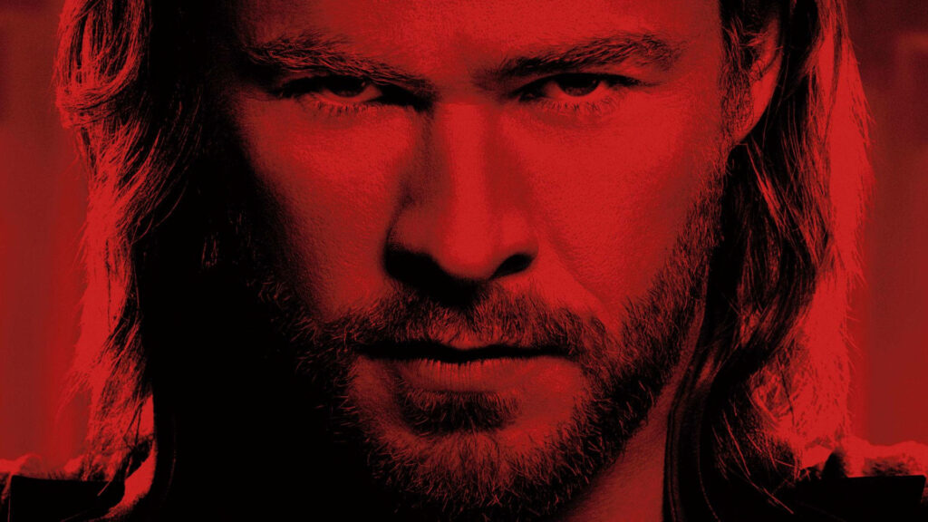 Chris Hemsworth intense close-up with dramatic red filter bold powerful wallpaper background