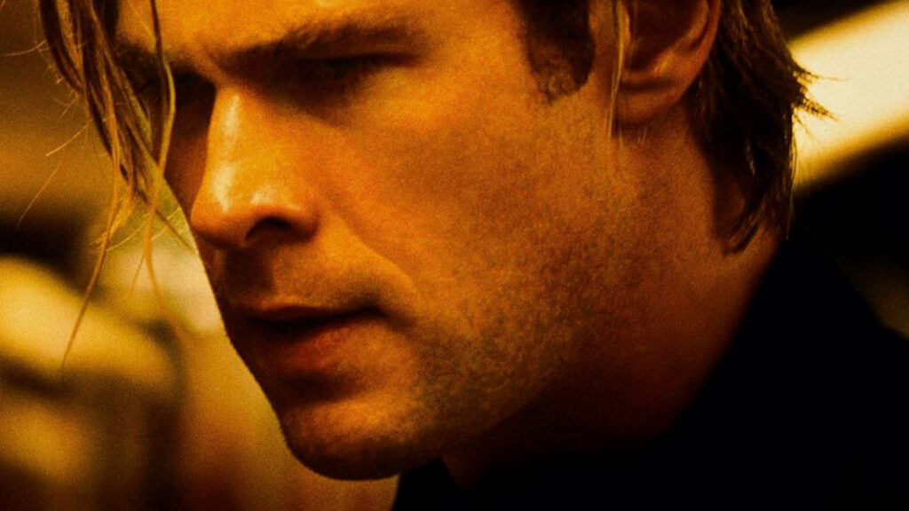 Chris Hemsworth intense expression portrait with crisp lighting striking wallpaper background
