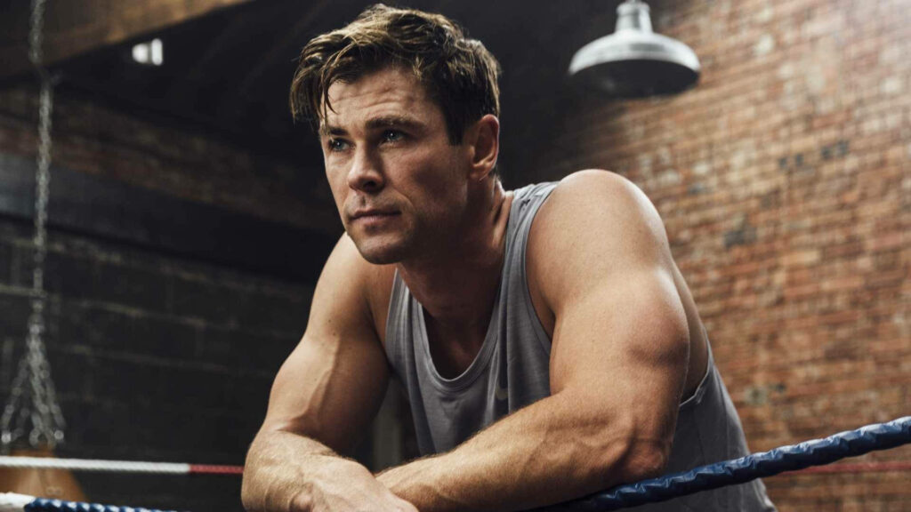 Chris Hemsworth intense gym workout showing strength fitness motivation inspiring background Wallpaper