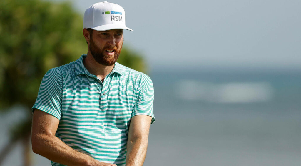 Chris Kirk focused on golf course with ocean background wearing striped shirt and RSM cap wallpaper