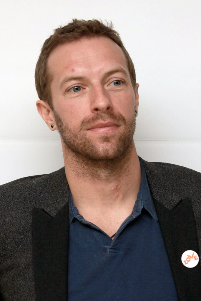 Close-up portrait of Coldplay’s Chris Martin with thoughtful expression and casual style wallpaper