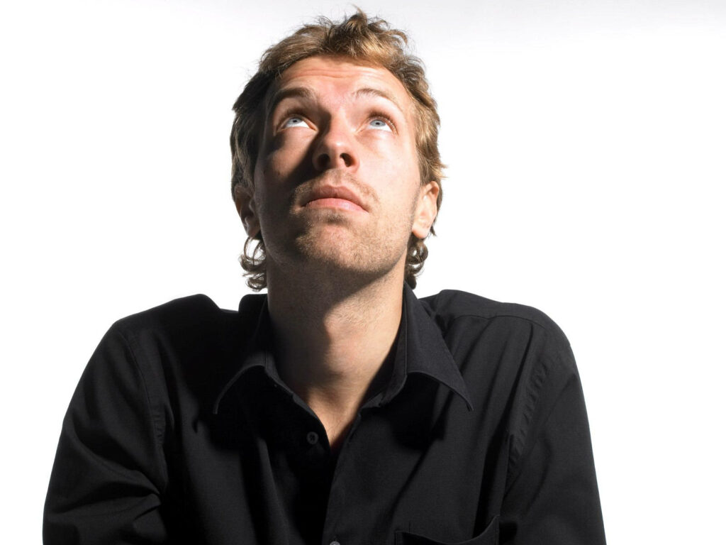 Chris Martin Coldplay minimalist portrait looking up white background soft lighting modern wallpaper