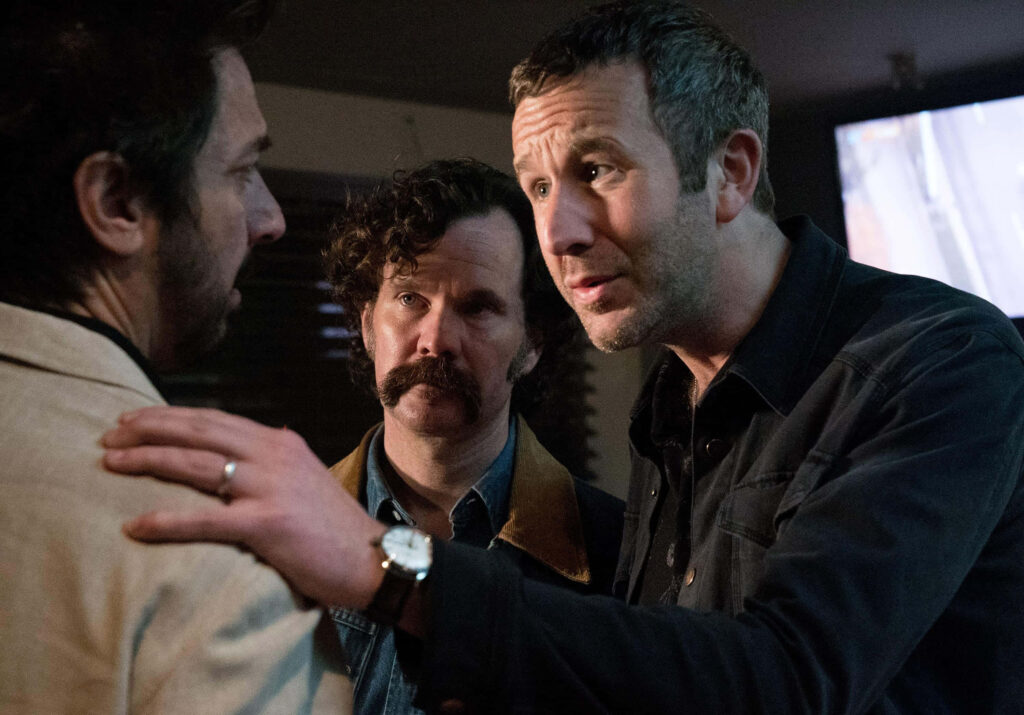 Chris O'Dowd and Sean Bridgers in intense dramatic scene from Get Shorty series with moody lighting Wallpaper