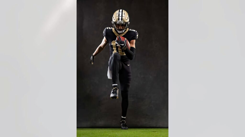 Chris Olave in New Orleans Saints uniform running mid-stride with dramatic dark background wallpaper