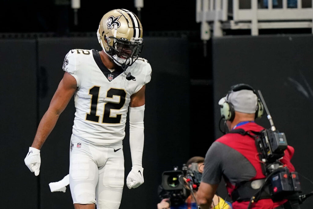 Chris Olave Saints number 12 celebrating passionately with black and gold NFL wallpaper background