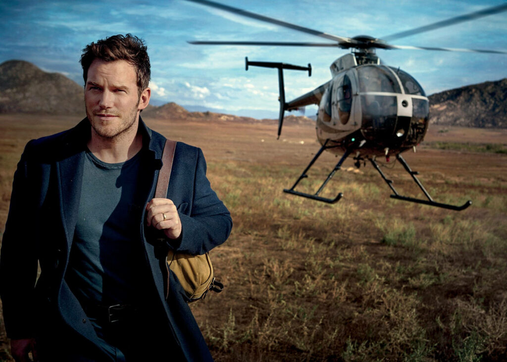 Chris Pratt on Vanity Fair cover in open field with helicopter earthy tones natural light wallpaper