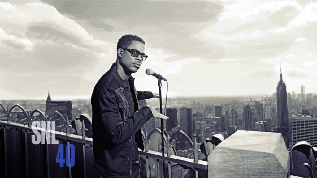 Chris Rock on rooftop with microphone in monochrome cityscape SNL 40 logo wallpaper background