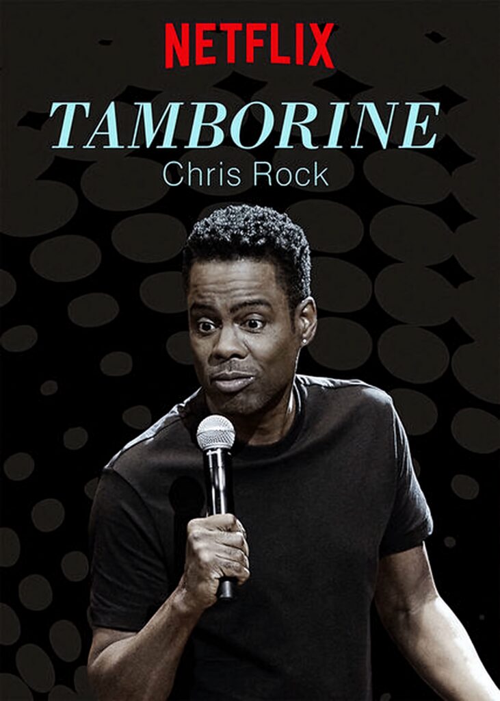 Chris Rock holding microphone in dark abstract background promoting Netflix stand-up Tamborine Wallpaper