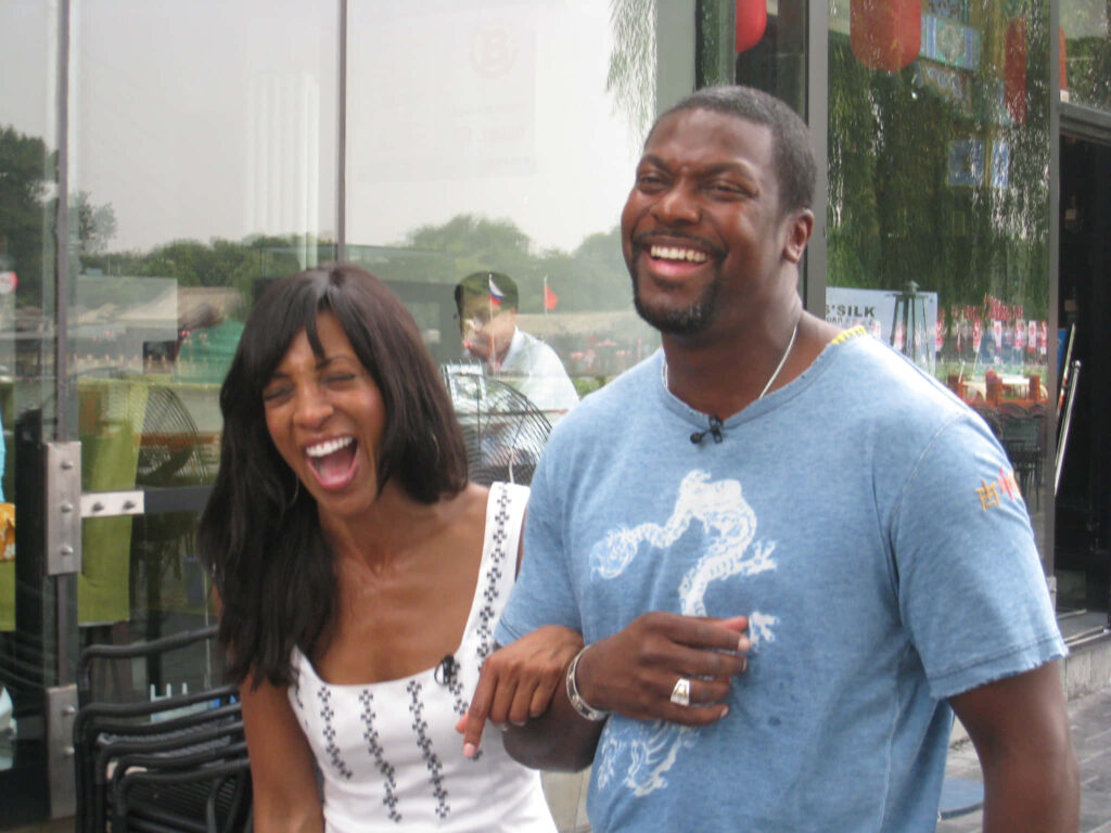 Chris Tucker laughing outdoors with a woman vibrant natural light casual urban summer vibes wallpaper