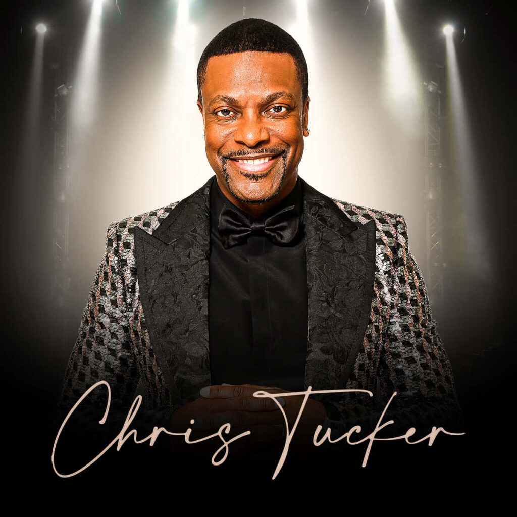 Chris Tucker in patterned suit black bow tie confident pose stage lights radiant smile wallpaper