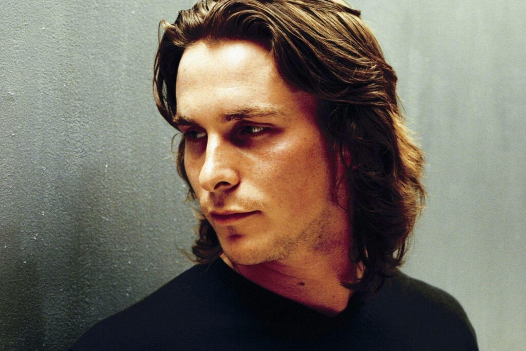 Christian Bale long hair contemplative expression minimalist wallpaper background portrait
