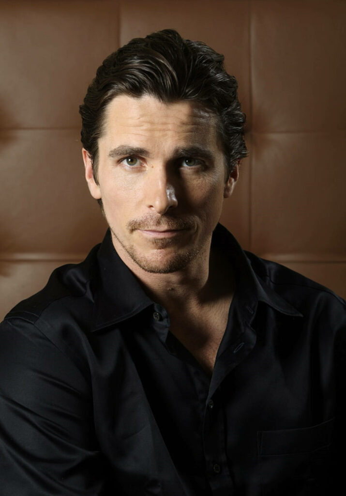 Portrait of British actor Christian Bale with confident expression cinematic wallpaper background