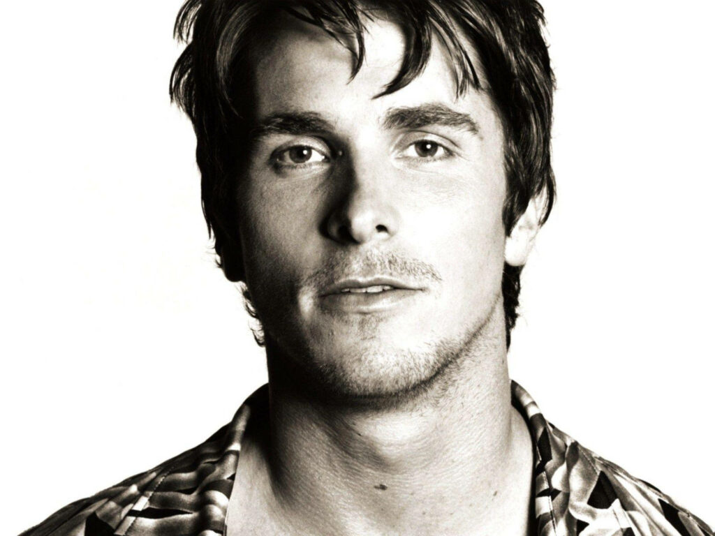 Sepia portrait of Christian Bale with relaxed expression showcasing distinctive features wallpaper