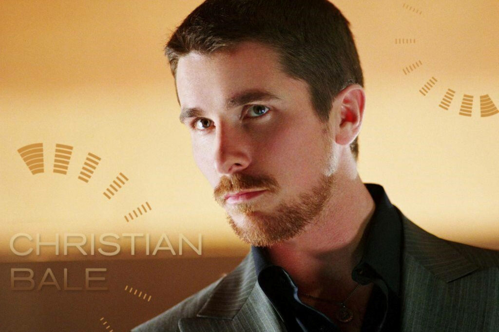 Christian Bale in sharp suit on golden background with stylish name text wallpaper background