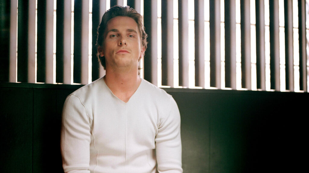 Christian Bale in white shirt sitting by slatted window natural light Time 100 wallpaper background