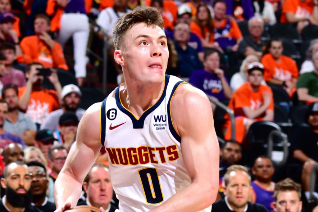 Christian Braun Denver Nuggets focused during game vibrant arena crowd dynamic basketball action Wallpaper