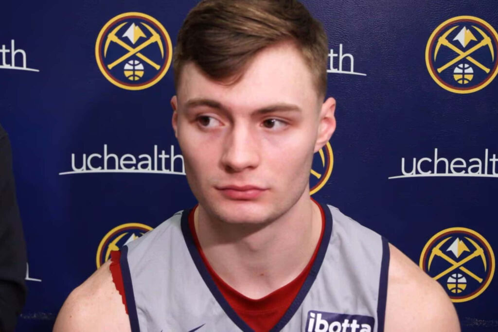 Christian Braun Denver Nuggets press conference focused expression team jersey wallpaper background