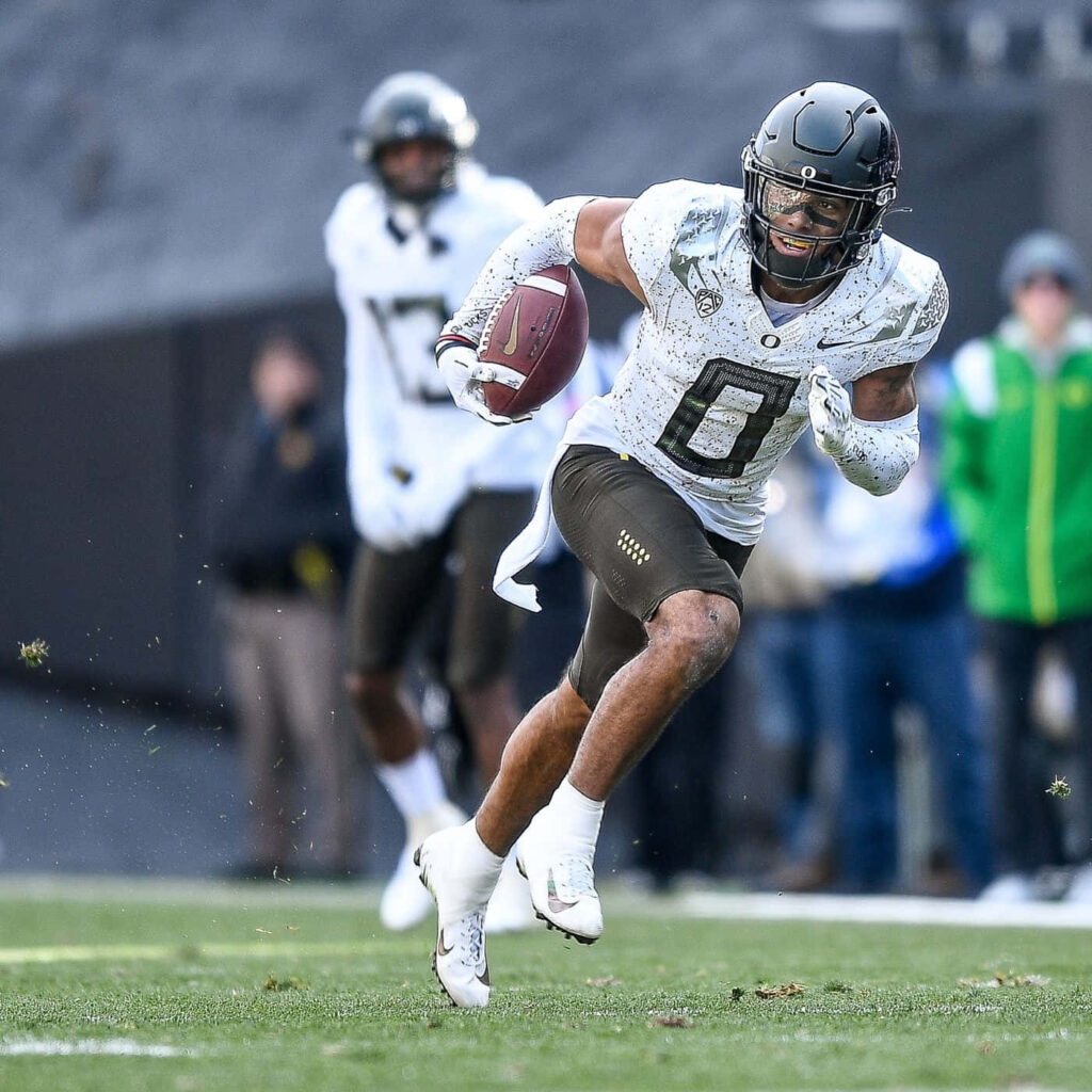 Christian Gonzalez football player in action on green field showing focus and athleticism wallpaper