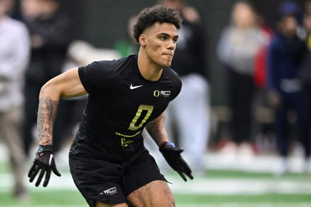 Christian Gonzalez in black uniform number 0 training football showing focus and athleticism Wallpaper