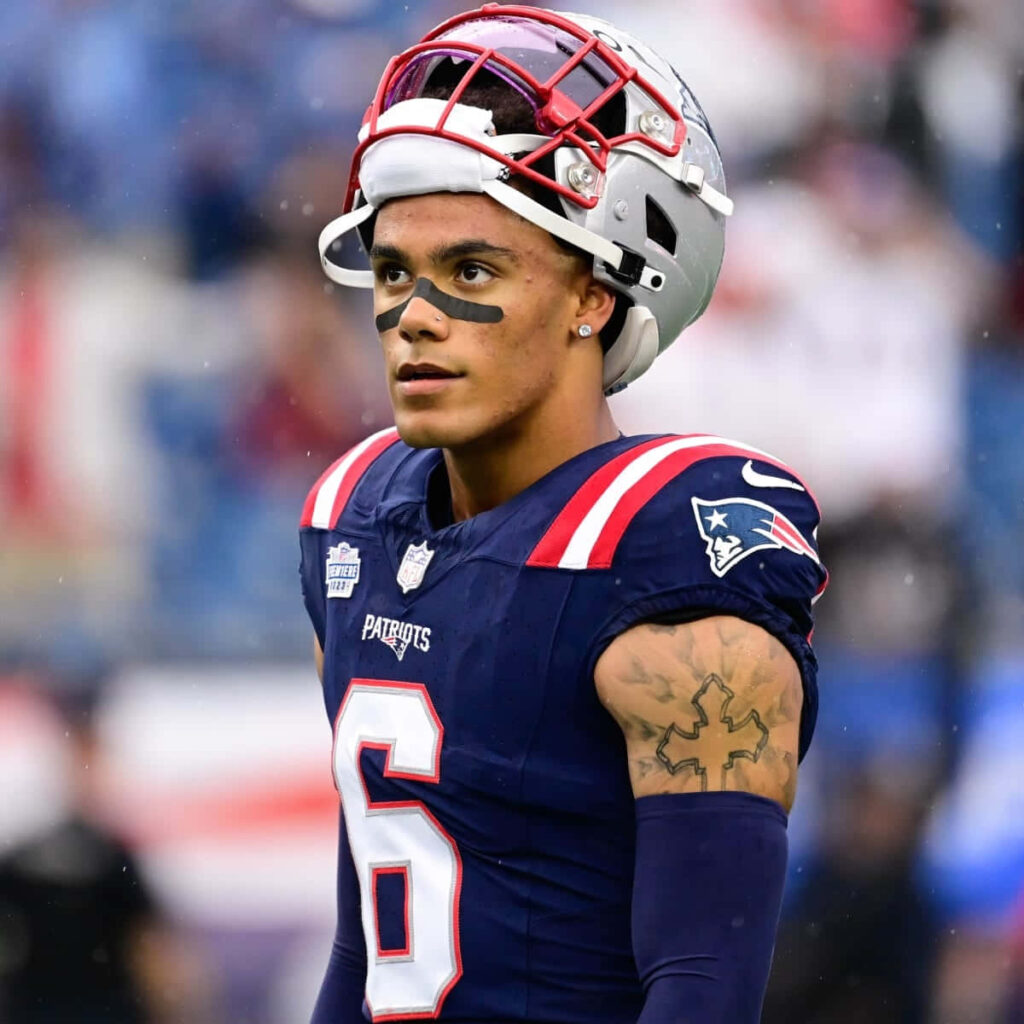 Christian Gonzalez NFL wallpaper Patriots uniform detailed helmet tattoos focused athlete