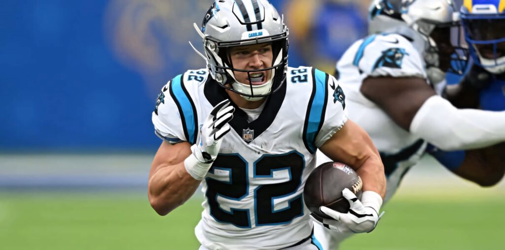 Christian McCaffrey Panthers rushing dynamic touchdown NFL game action vibrant team colors Wallpaper