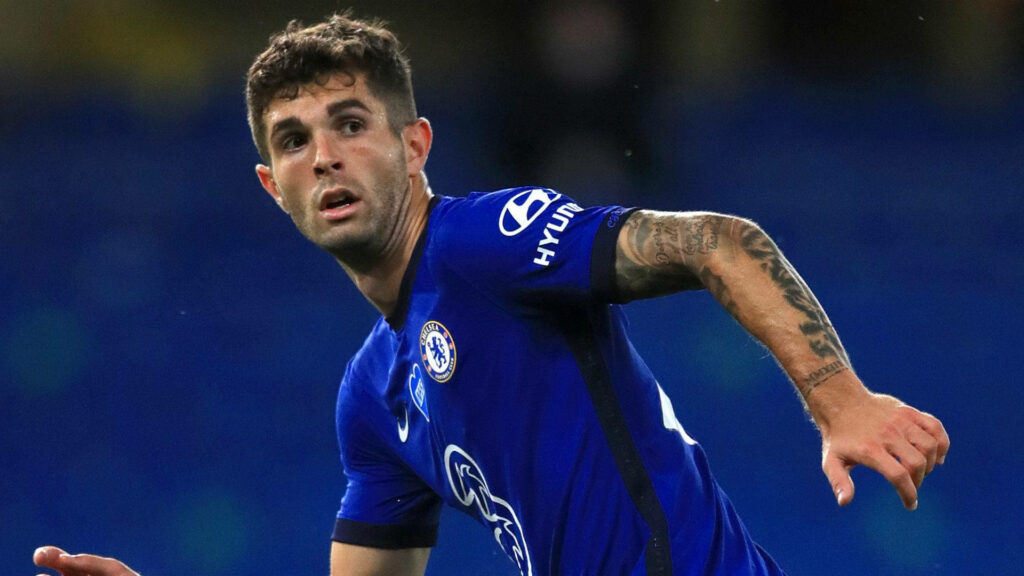 Christian Pulisic Chelsea wallpaper mid-action focused expression blue tones detailed tattoos
