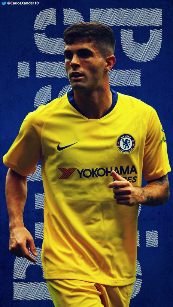 Christian Pulisic in Chelsea yellow away kit mid-action football wallpaper with blue textured background