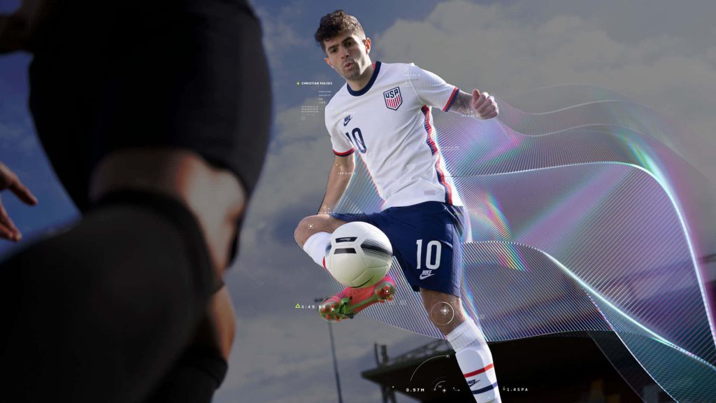 Christian Pulisic in USA kit controlling ball FIFA 22 wallpaper with futuristic gaming HUD background