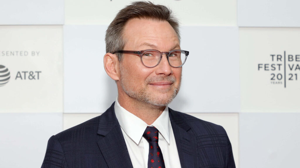 Christian Slater formal suit and tie wallpaper with geometric patterns and modern eyeglasses