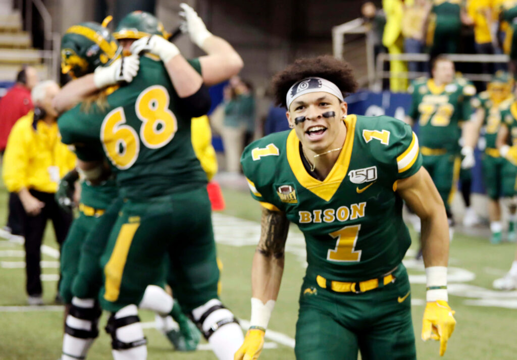 Christian Watson Bison football celebration vibrant wallpaper green yellow uniforms victory energy