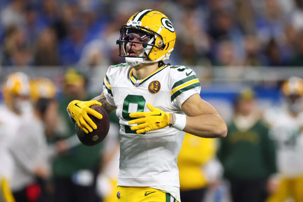 Christian Watson Green Bay Packers wide receiver catching football in vibrant game action wallpaper
