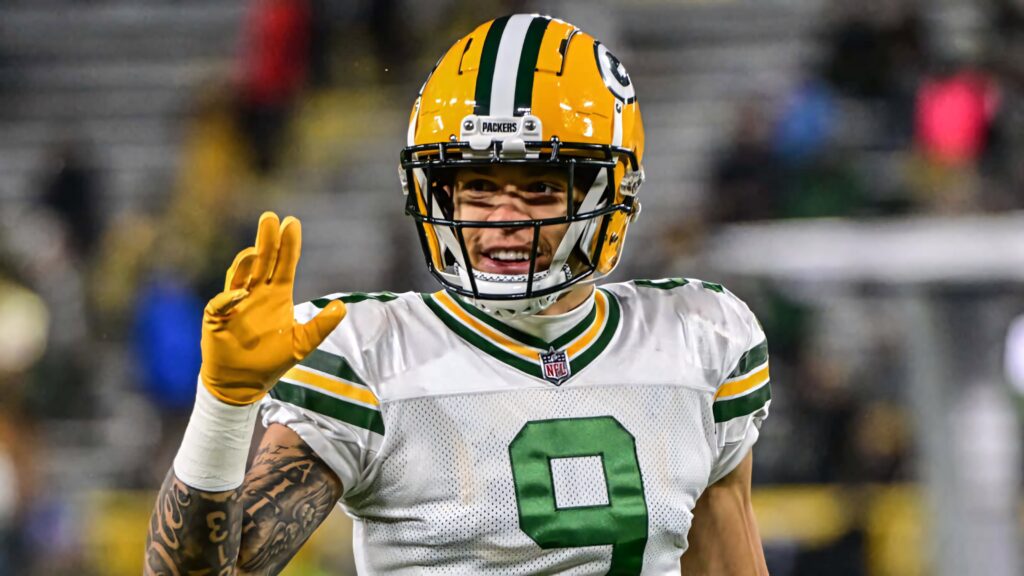 Christian Watson Green Bay Packers celebrating football touchdown dynamic action stadium background Wallpaper