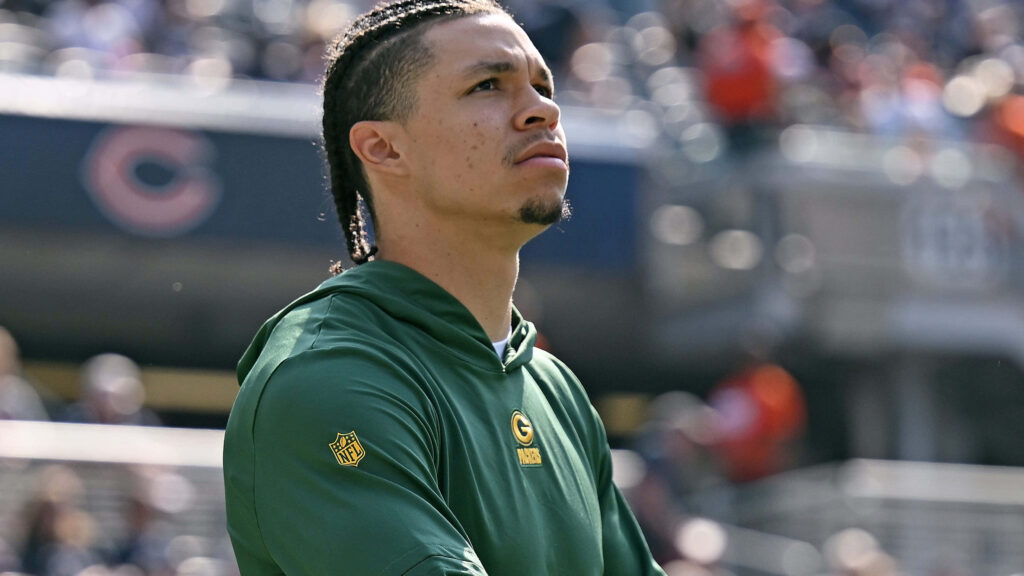 Christian Watson Green Bay Packers focused in hoodie blurred stadium natural light sports wallpaper
