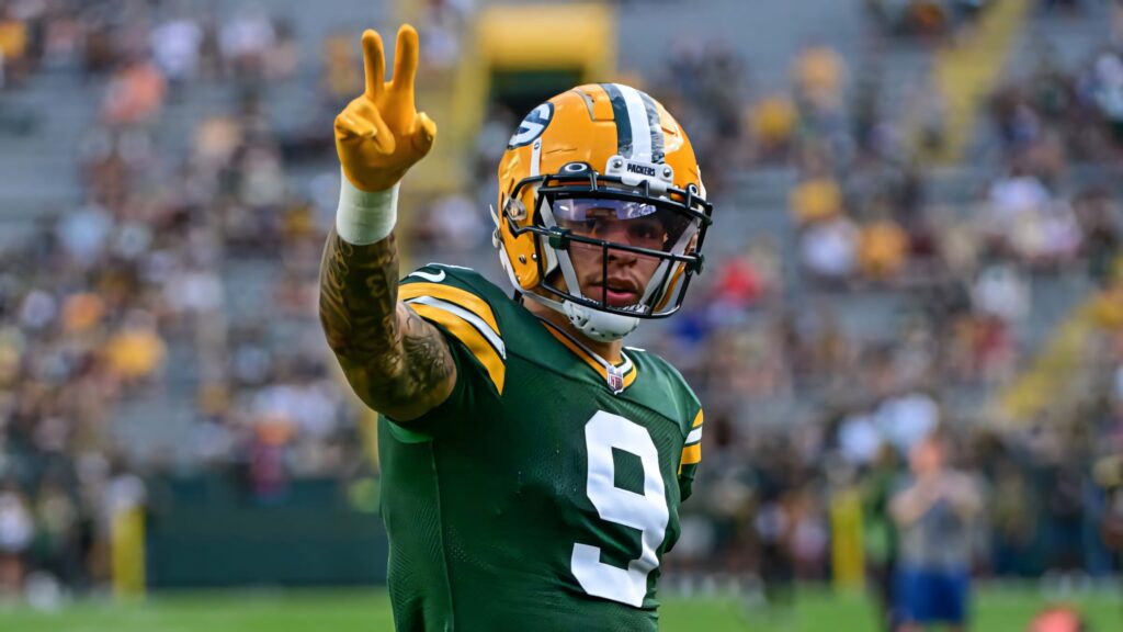 Christian Watson Green Bay Packers victory sign NFL player in green and gold uniform on field Wallpaper