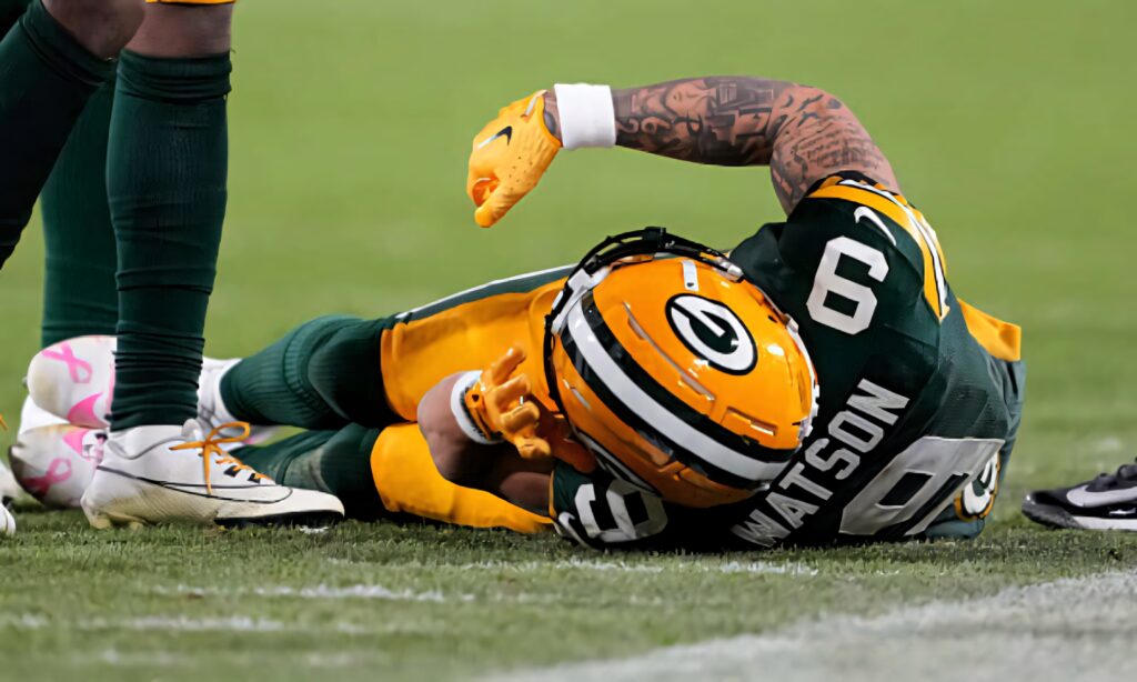 Christian Watson Green Bay Packers injured on field intense football game action wallpaper background