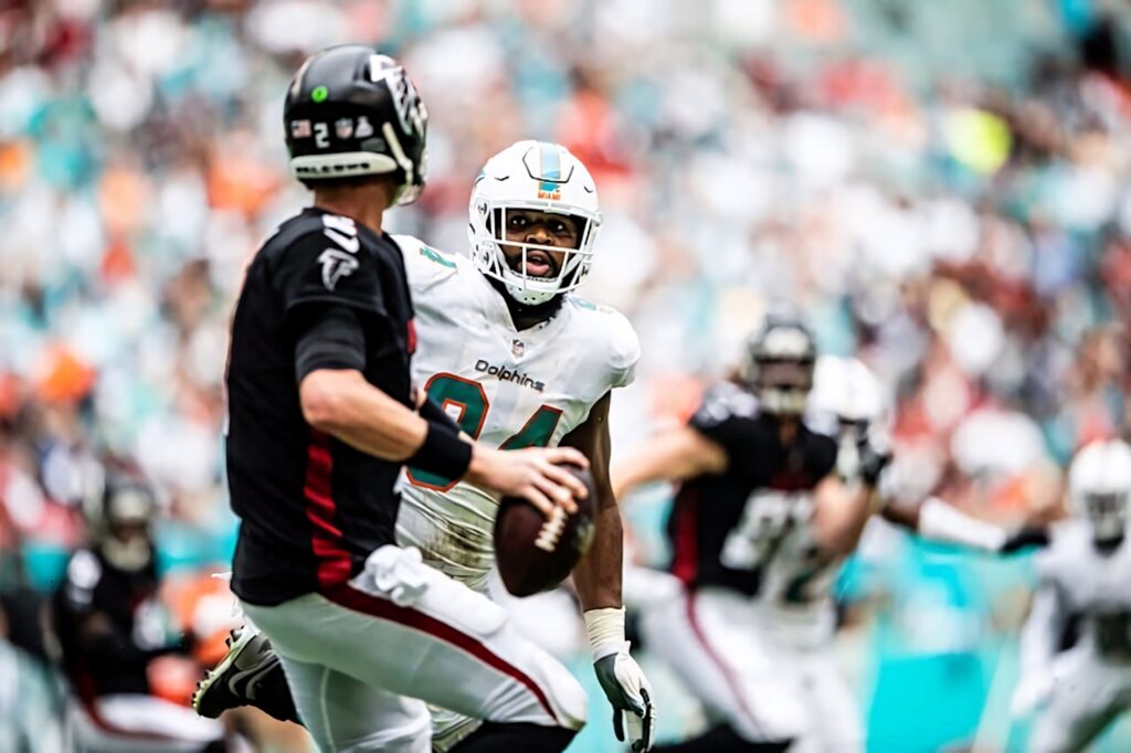 Christian Wilkins charging quarterback in Miami Dolphins game vibrant colors dynamic NFL action wallpaper