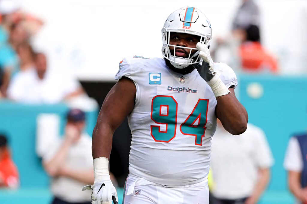 Christian Wilkins Miami Dolphins defensive tackle in number 94 jersey vibrant game day scene Wallpaper