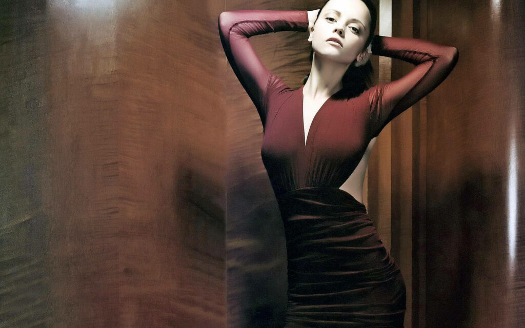 Christina Ricci elegant in deep red dress warm background sophisticated wallpaper image