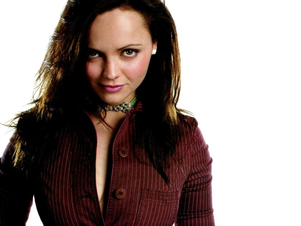 Christina Ricci in maroon pinstriped top confident pose stylish white background wallpaper